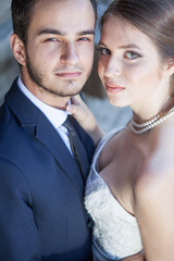 Portrait of wife and groom looking up at the camera. Just married couple