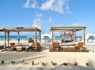 Beach cabanas and chairs on a white sandy beach