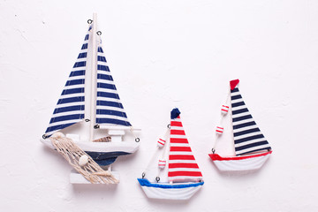 Three  decorative  wooden toys boats on textured  white background.