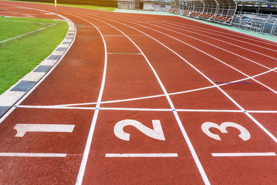 Red running track in stadium with number in lanes. Business Investment Competition Concepts