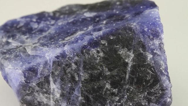 Sodalite, blue tectosilicate mineral ornamental gemstone isolated on a white background