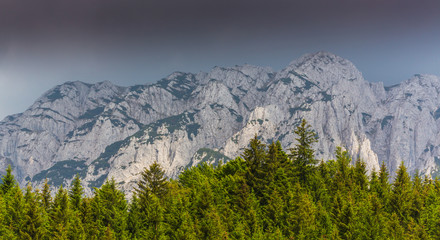 Fototapeta na wymiar Dramatic scenery in Piatra Craiului Mountains, Romania, with beautiful mist clouds and limestone peaks