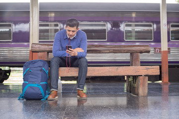 man traveler with backpacker look searching location in phone, travel concept