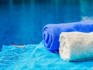 Blue and white towels at the side of swimming pool. Vacation, beach, summer travel concept