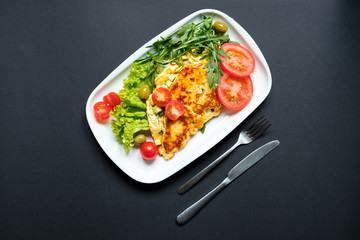 Tomato omelette served with fresh salad.