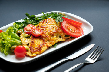 Tomato omelette served with fresh salad.