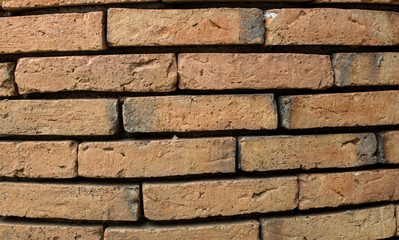 The background of the ancient brick wall is not very close together.