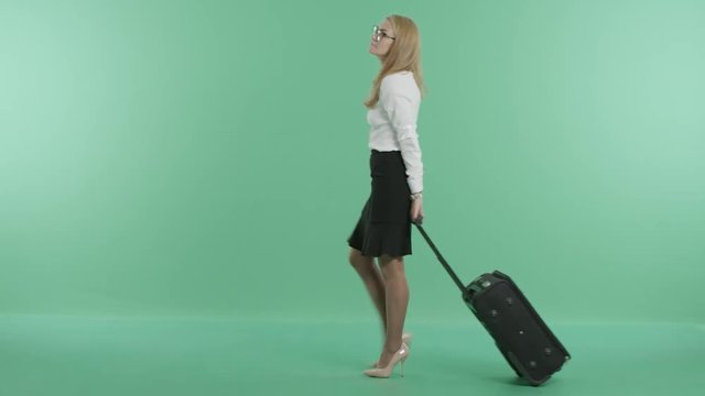 a businesswoman is walking with luggage