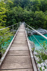 Fototapeta na wymiar Wooden Bridge over rover Soca, Slovenia
