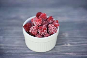 Frozen berry raspberry with white hoarfrost