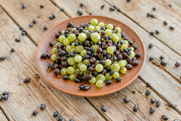 Gooseberry and Blackcurrant on a wooden table. It can be used as a background