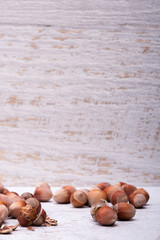 Hazelnuts on white wooden background in studio photo