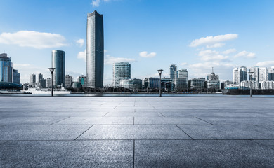 Obraz premium empty brick platform with Shanghai skyline in background.
