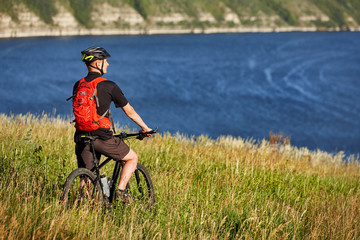 Active bicyclist at the riverside