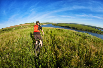 Active bicyclist at the riverside