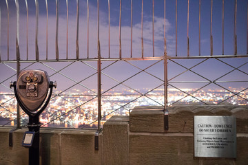 Binoculars on top of Empire State Building at Night in Manhattan, New York