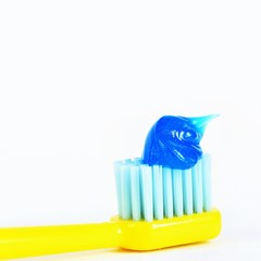 Toothbrush with paste on a white background.
