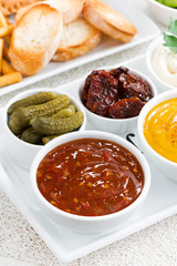 sweet and sour tomato sauce and a variety of snacks, vertical