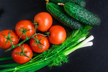 Fresh vegetables on a black background.