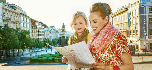 mother and daughter tourists looking at the map in Prague