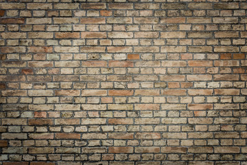 Old orange brick wall texture grunge background with vignetted corners