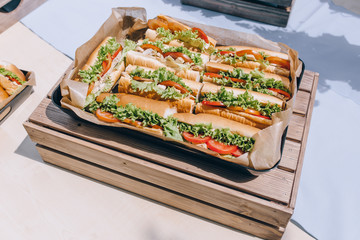  fresh submarine sandwiches with ham, cheese, bacon, tomatoes, lettuce, cucumbers and onions