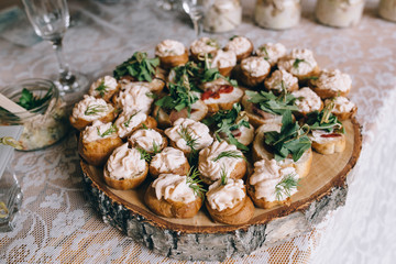 Beautifully decorated catering banquet table with different food snacks and appetizers on corporate christmas birthday party event or wedding celebration