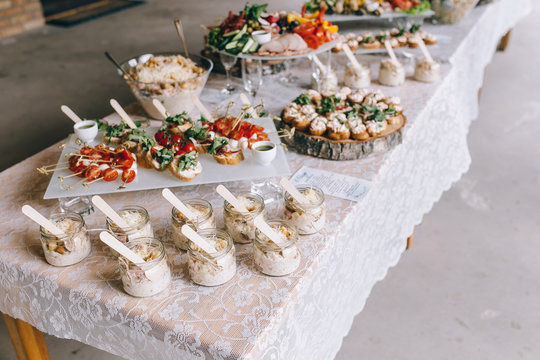 Beautifully decorated catering banquet table with different food snacks and appetizers on corporate christmas birthday party event or wedding celebration