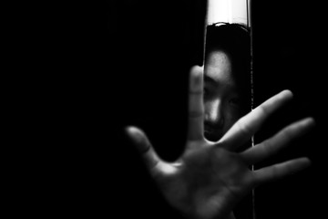 fear girl hiding in closet with hand reaching out