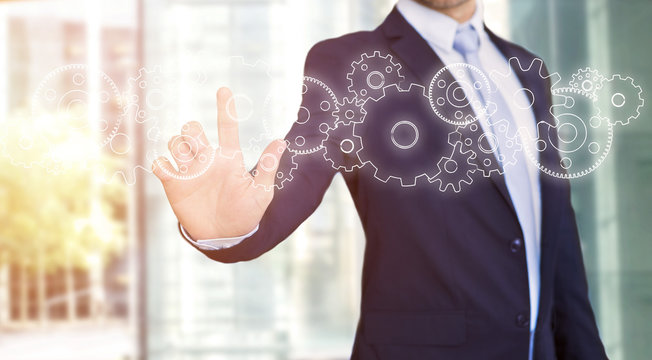 Businessman touching technology interface with gear wheel setting