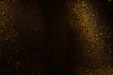 Fototapeta na wymiar splashing water reflect light in gold