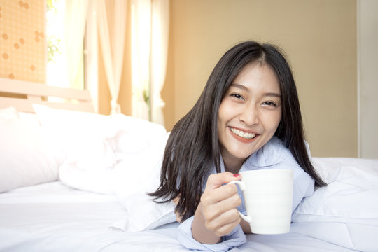 Happy young asian woman hold coffee cup with attractive smiling, 20-25 years old.