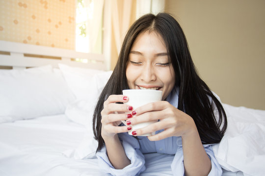 Happy young asian woman hold coffee cup with attractive smiling, 20-25 years old.