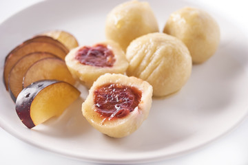 Austrian traditional dumplings filled with plum on white