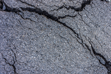 Surface of cracked asphalt pavement. It was greatly damaged by natural disasters.