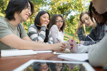 Multiethnic group of happy young students studying