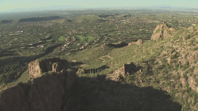 Aerial View of Desert Mountains With A Golf Course In The Distance