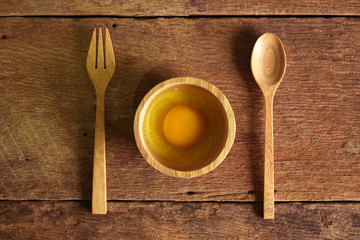 eggs with wood spoon on wood  background.