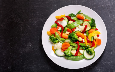 Fototapeta na wymiar plate of stir fry vegetables, top view