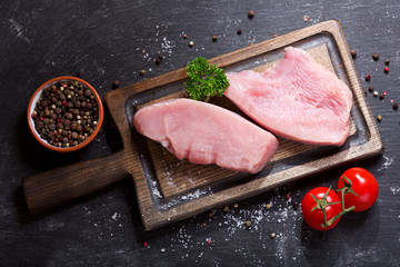 fresh chicken meat on wooden board