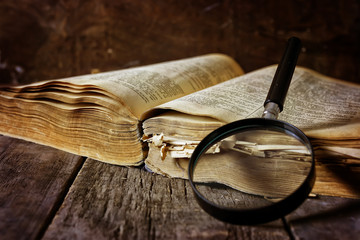 magnifying glass and old book
