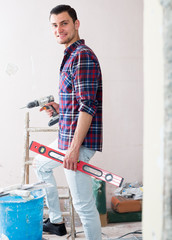 Portrait of young smiling man which is ready for renovation.