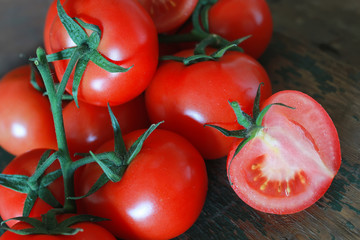 branch of tomatoes on wooden background