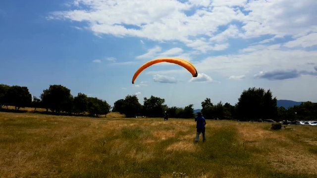 View of a tandem paraglider above the mountain valley. Flying in tandem.