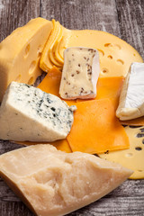 Different type of cheese on wooden background. Gourmet food apetizer