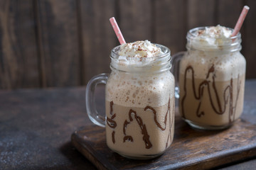 Cold coffee drink frappe frappuccino with whipped cream and chocolate syrup