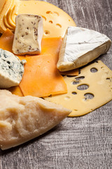 Different type of cheese on wooden background. Gourmet food apetizer