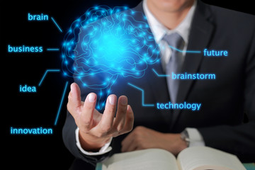 businessman hand hold the blue glowing brain as business, idea, innovation, future, brainstorm, control and technology concept.