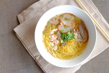 spicy pork noodles on wood floor