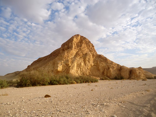 Cliff in the desert against a blue sky with clouds wallpaper